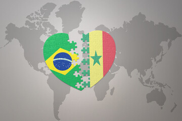puzzle heart with the national flag of brazil and senegal on a world map background.Concept.