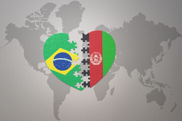 puzzle heart with the national flag of brazil and afghanistan on a world map background.Concept.