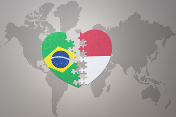 puzzle heart with the national flag of brazil and indonesia on a world map background.Concept.