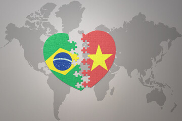 puzzle heart with the national flag of brazil and vietnam on a world map background.Concept.