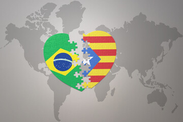 puzzle heart with the national flag of brazil and catalonia on a world map background.Concept.