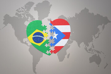 puzzle heart with the national flag of brazil and puerto rico on a world map background.Concept.