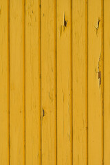 Vertical frame, yellow wooden background, old house wall, paint peeling off the wall, wallpaper...