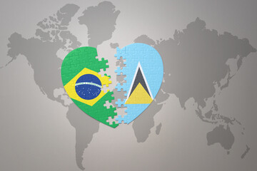 puzzle heart with the national flag of brazil and saint lucia on a world map background.Concept.