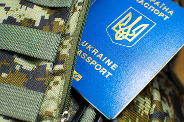 Ukrainian biometric passport on the military backpack. Ukrainian soldiers. Army concept. Stop war.