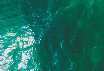 Aerial Drone photo. Beautiful turquoise green water background on summer sea beach. Relax and travel concept. Warm sunny weather.