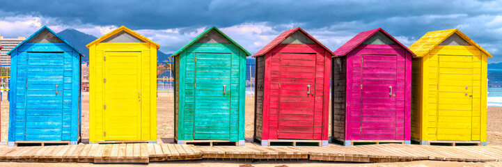 Spanish beach huts panoramic view with bright colours with red green blue yellow purple - Powered by Adobe