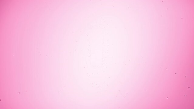 Exclamation sign printed on the wet glass blown off with air stream on pink background | warning concept