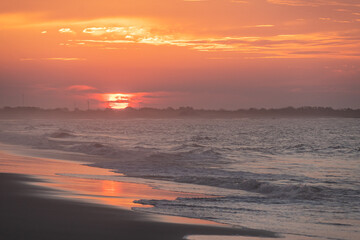 Ocean waves at sunrise off the shore of Cape May , New Jersey USA