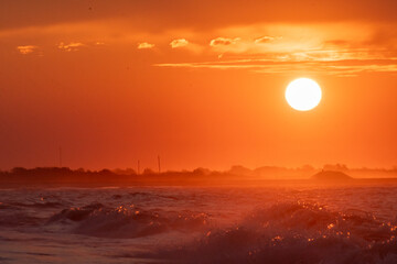 Ocean waves at sunrise off the shore of Cape May , New Jersey USA