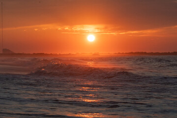 Ocean waves at sunrise off the shore of Cape May , New Jersey USA