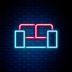 Glowing neon line Sofa icon isolated on brick wall background. Colorful outline concept. Vector