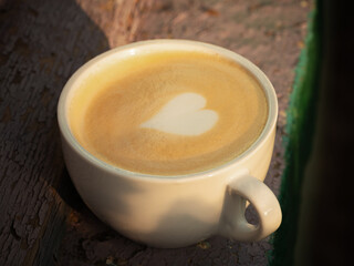 Cup of cappuccino on windowsill in natural light. close up