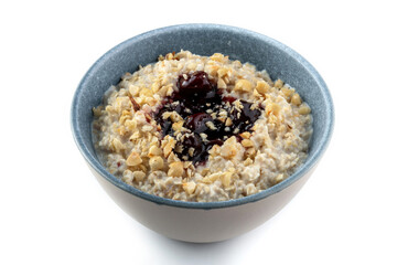 Tasty oatmeal with jam in bowl on white background.