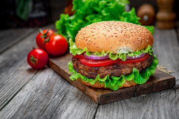 Fresh tasty burger on wood table