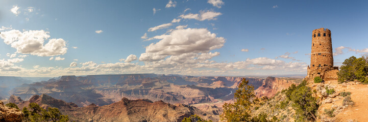 Fototapeta na wymiar Panoramic views from the rim of Grand Canyon in Arizona, USA. Stunning tourism tourist area in panorama view with blue sky, clouds. 