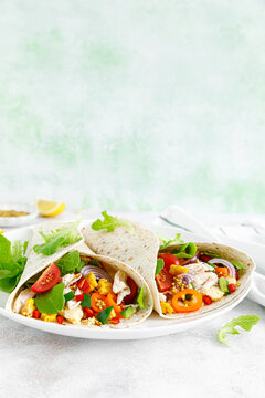 Mexican tacos with chicken meat and vegetables
