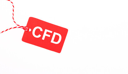 The inscription CFD Contract for Difference on a red price tag on a light background. Advertising concept. Copy space