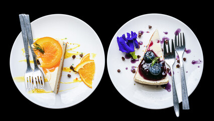 orange cheese cake and blueberry cheese cake in white plate on black background