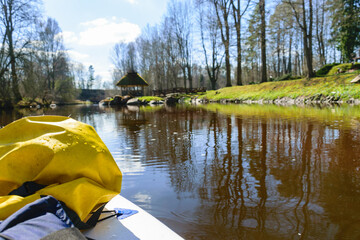 view from paddle board to wild river on a sunny spring day, active holidays outdoors