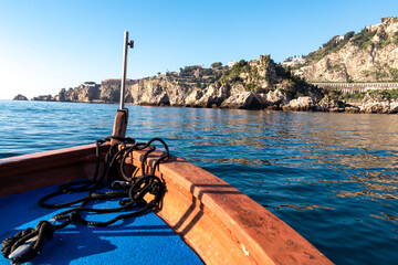 Touristic boat tour with panoramic view on the coastline near Isola Bella in Taormina, Sicily,...