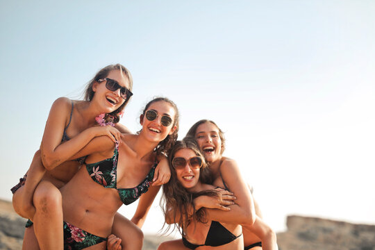 group of smiling girls at the beach