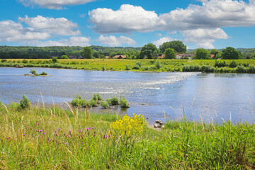 View from belgian border over river Maas rapids for rafting on dutch riverfront, idyllic rural...