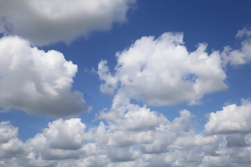 Naklejka na ściany i meble Isolated blue summer sky cloudscape photo with white fluffy fair weather cumulus clouds