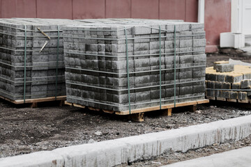 New paving slabs neatly stacked on pallets.