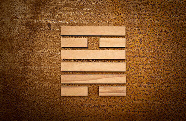 wooden Gene Key 50 i ging hexagram on rusty metal background human design