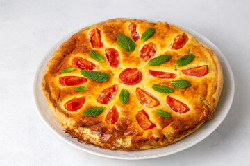 Vegetarian homemade pie, Quiche with tomatoes, spinach and feta cheese, spinach quiche (Turkish name; ispanakli kis)