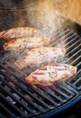 Barbecue lamb saddle back chop steak grilled as close-up on a charcoal grill with fire