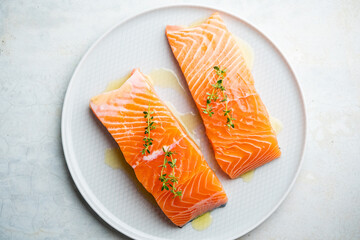 Fresh salmon fillet with herbs on a plate for delicious salmon steak.