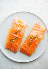 Fresh salmon fillet with herbs on a plate for delicious salmon steak.