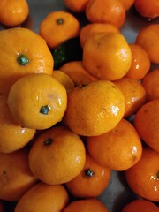 Group of wet ripe tangerines close up..