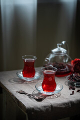 Hot red karkade tea in a glasses on rustic background