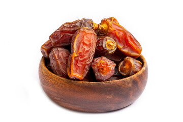 Dried date palm fruits in wooden bowl on white background
