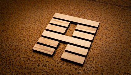 wooden Gene Key 52 i ging hexagram on rusty metal background human design