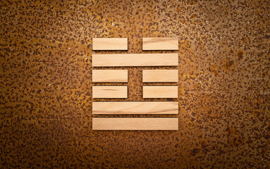 wooden Gene Key 60 i ging hexagram on rusty metal background human design