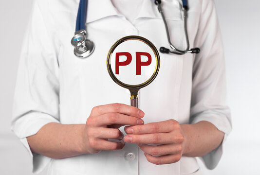 PP vitamin, word acronym through magnifying glass. High quality photo