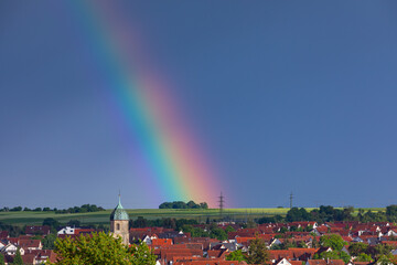 beautiful rainbow behind church tower