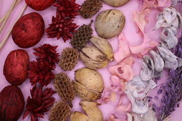 Potpourri in red, brown, pink and white on a pink background