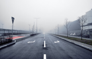 Asphalt road in the fog in the city. - obrazy, fototapety, plakaty