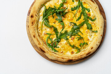 Freshly baked crispy pizza with bacon, ham, arugula and cheese on white background. Delivery food. View from above. Blonde pizza.