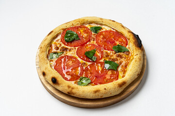 Italian pizza with cherry tomatoes and green basil on white background