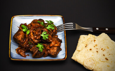 Stewed beef liver with onions and fresh herbs 