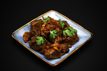 Stewed beef liver with onions and fresh herbs 