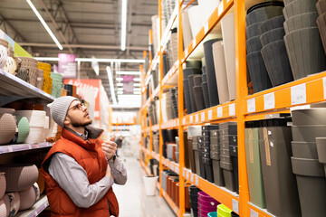 hardware store customer chooses plant pot