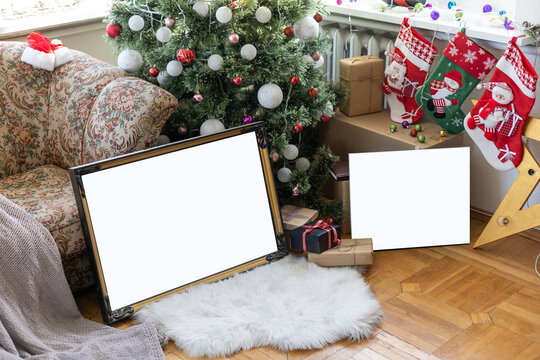 Empty blank photo frame in christmas decorated background with toys and candle lights.