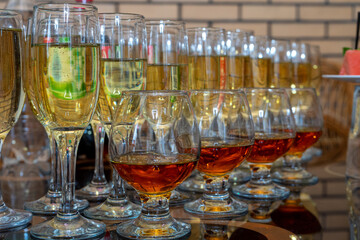 Many different glasses with white and red wine photographed close up